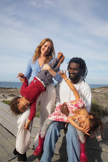 Upside-down giggles on a bench by the sea