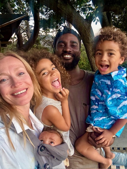 A family selfie under the trees, everyone laughing