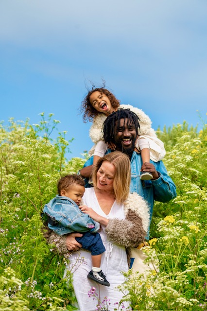 The family laughing in a field of wildflowers